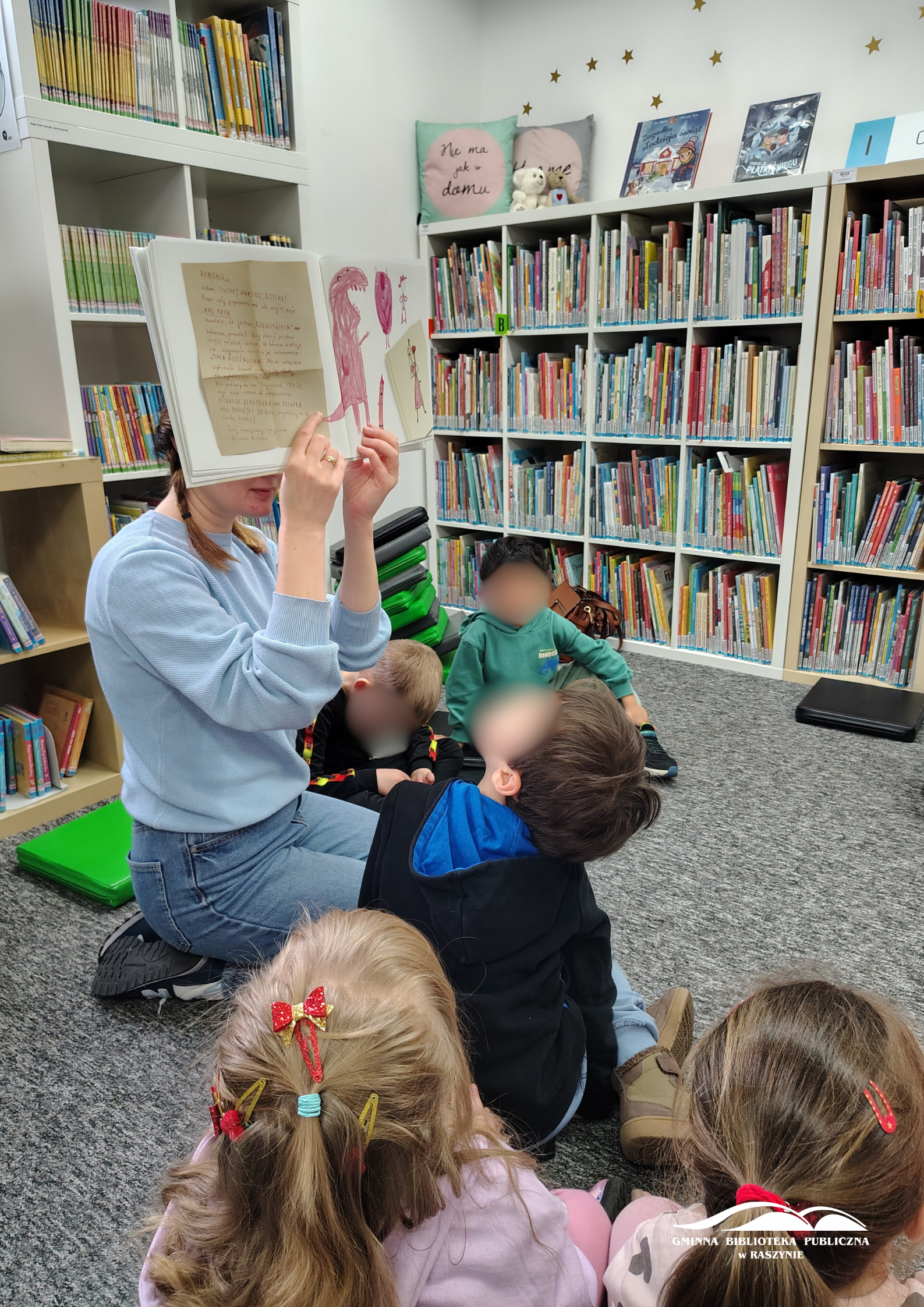 Bibliotekarka pokazuje ilustracje z książki "Dzień w którym kredki miały dość"